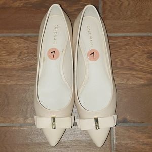 Cole Haan flat shoes with bow and gold accent.